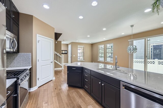 11323 Uptown Ave, Broomfield, CO 80021 - kitchen featuring recessed lighting, a sink, baseboards, light wood-style flooring, and appliances with stainless steel finishes