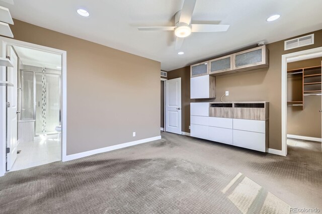11323 Uptown Ave, Broomfield, CO 80021 - unfurnished bedroom with baseboards, visible vents, carpet floors, and a walk in closet