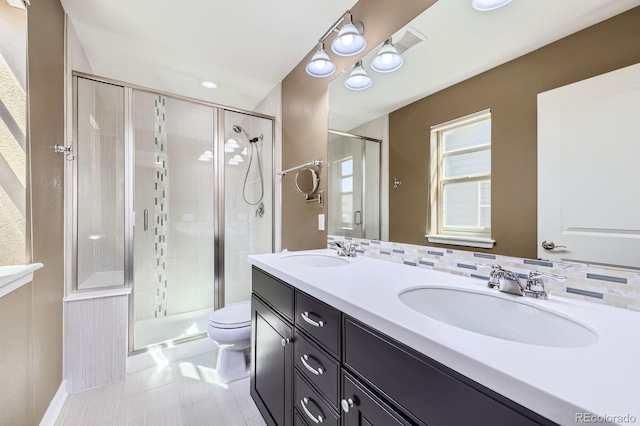 11323 Uptown Ave, Broomfield, CO 80021 - bathroom with double vanity, a shower stall, toilet, and a sink