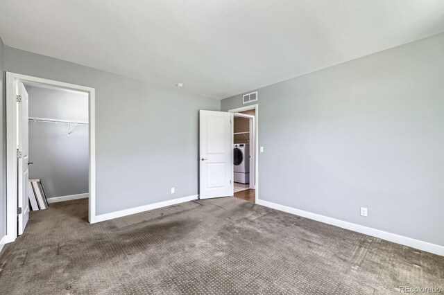 11323 Uptown Ave, Broomfield, CO 80021 - unfurnished bedroom with baseboards, visible vents, a spacious closet, and washer / clothes dryer