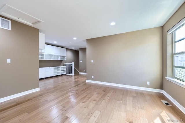 11323 Uptown Ave, Broomfield, CO 80021 - empty room with light wood-style flooring, visible vents, and a healthy amount of sunlight
