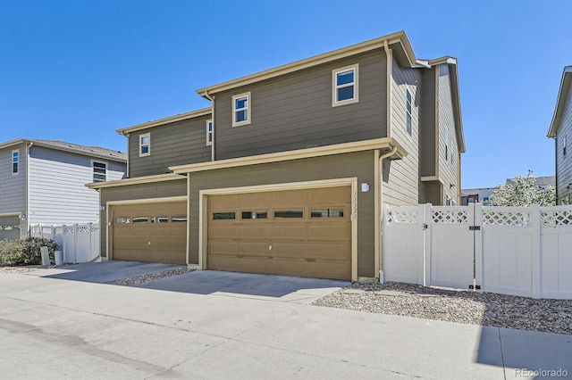 11323 Uptown Ave, Broomfield, CO 80021 - view of front of home featuring an attached garage, fence, and driveway