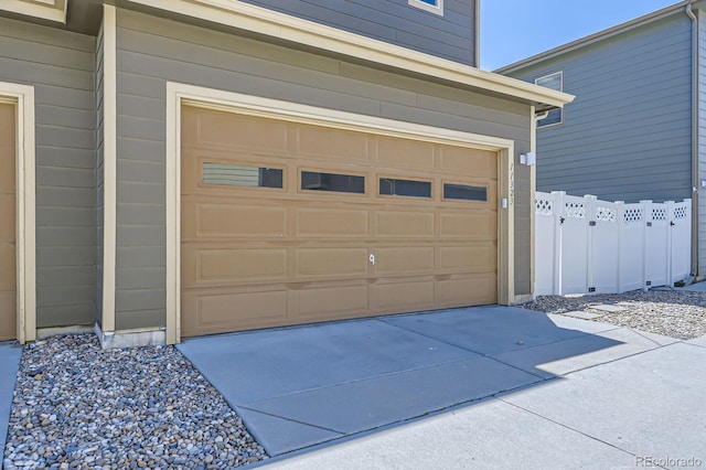 11323 Uptown Ave, Broomfield, CO 80021 - garage featuring driveway and fence