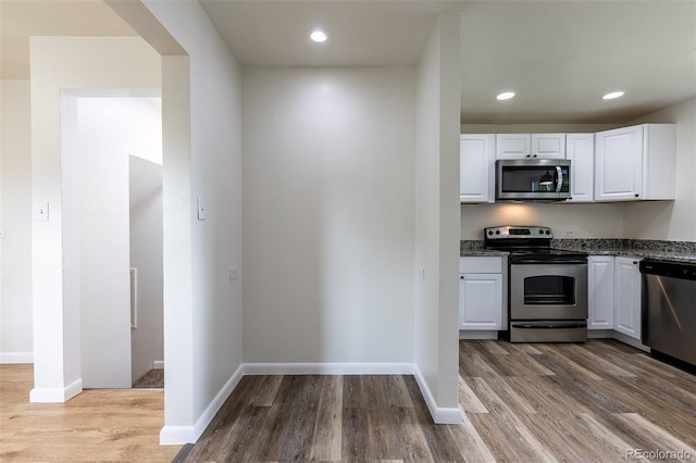 3256 S Ogden St, Englewood, CO 80113 - kitchen featuring stainless steel appliances, white cabinetry, wood finished floors, baseboards, and recessed lighting