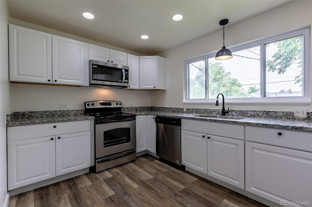 3256 S Ogden St, Englewood, CO 80113 - kitchen featuring appliances with stainless steel finishes, a sink, white cabinets, stone countertops, and recessed lighting