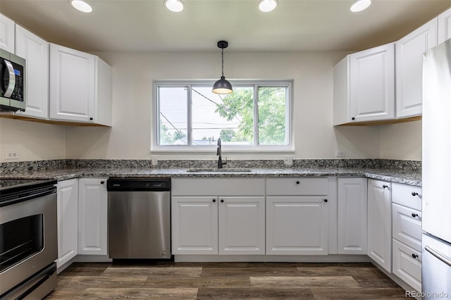 3256 S Ogden St, Englewood, CO 80113 - kitchen with appliances with stainless steel finishes, a sink, recessed lighting, white cabinetry, and pendant lighting