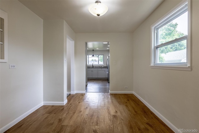 3256 S Ogden St, Englewood, CO 80113 - empty room featuring wood finished floors, baseboards, and a sink