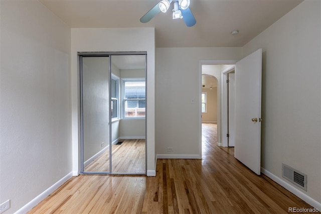 3256 S Ogden St, Englewood, CO 80113 - unfurnished bedroom featuring wood finished floors, multiple windows, baseboards, and a closet