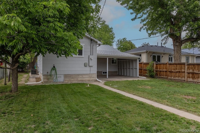 3256 S Ogden St, Englewood, CO 80113 - back of property with a patio, a sunroom, central air condition unit, and roof with shingles