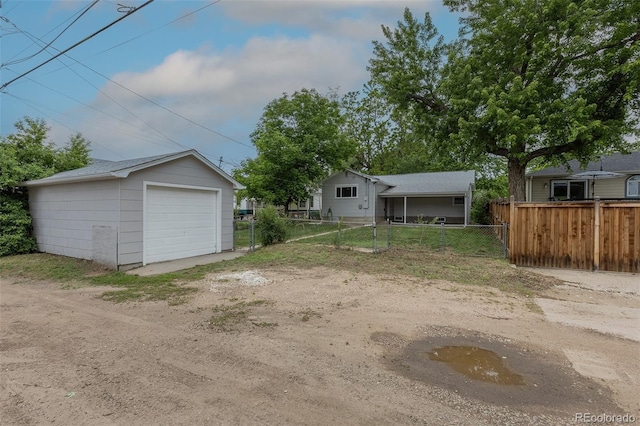 3256 S Ogden St, Englewood, CO 80113 - fenced yard with driveway, a garage, and an outdoor structure