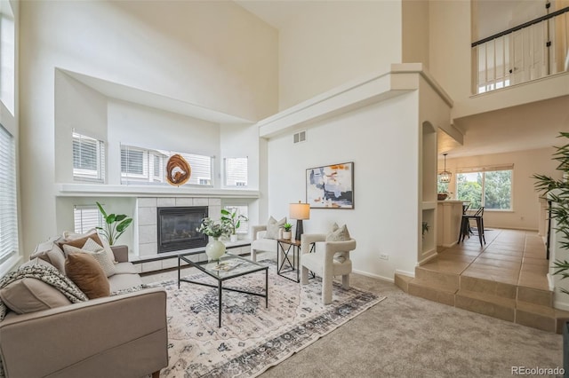 4807 Fenwood Dr, Highlands Ranch, CO 80130 - carpeted living area featuring a high ceiling and a tile fireplace