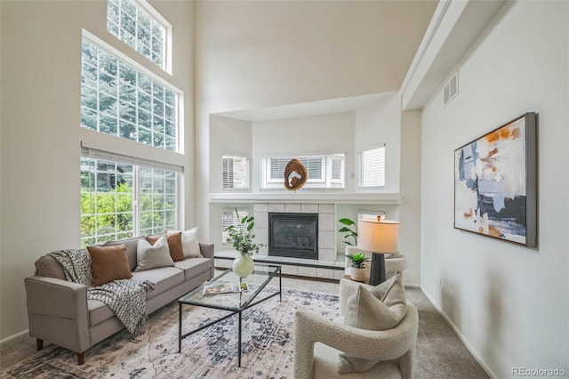 4807 Fenwood Dr, Highlands Ranch, CO 80130 - carpeted living area with a towering ceiling, plenty of natural light, and a tiled fireplace