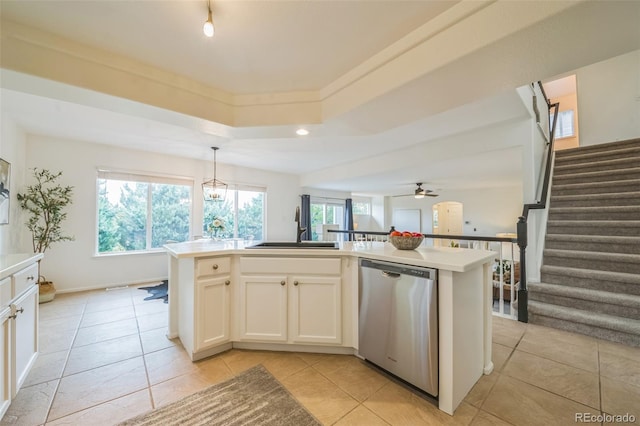 4807 Fenwood Dr, Highlands Ranch, CO 80130 - kitchen featuring stainless steel dishwasher, light tile patterned floors, an island with sink, white cabinetry, and ceiling fan