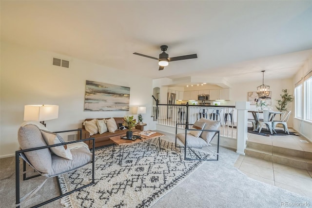 4807 Fenwood Dr, Highlands Ranch, CO 80130 - living area with a chandelier, light carpet, and ceiling fan