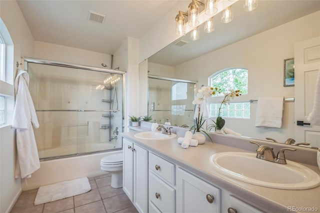 4807 Fenwood Dr, Highlands Ranch, CO 80130 - full bathroom featuring tile patterned flooring, double vanity, and bath / shower combo with glass door