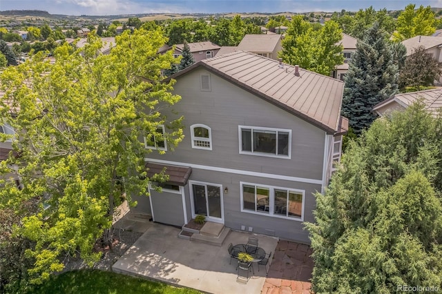 4807 Fenwood Dr, Highlands Ranch, CO 80130 - rear view of property featuring a standing seam roof, a patio area, and a metal roof