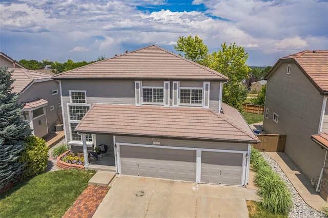 4807 Fenwood Dr, Highlands Ranch, CO 80130 - view of front of home with driveway, a tiled roof, and an attached garage