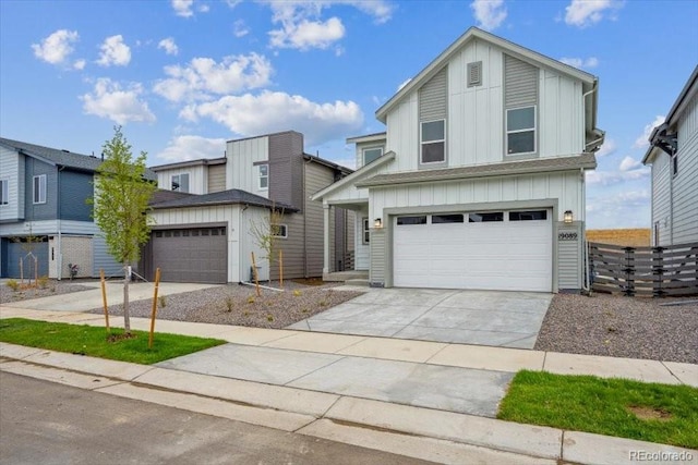 view of front facade featuring board and batten siding, a garage, driveway, and fence