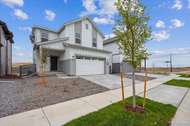 view of front of home featuring board and batten siding, a garage, and driveway