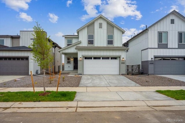 view of front of house with an attached garage, board and batten siding, and driveway