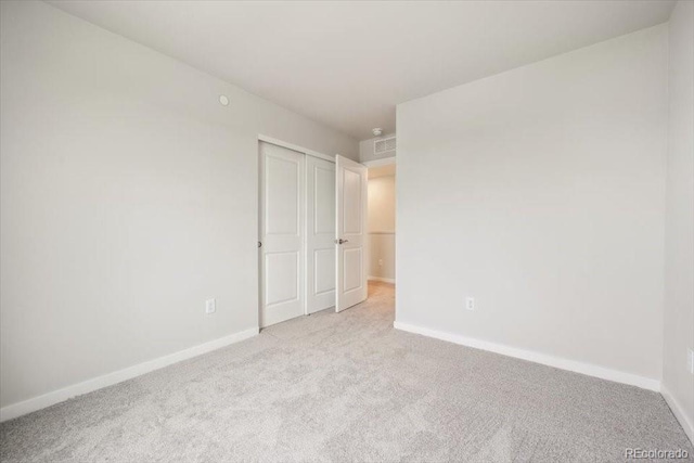 unfurnished bedroom featuring baseboards and carpet floors