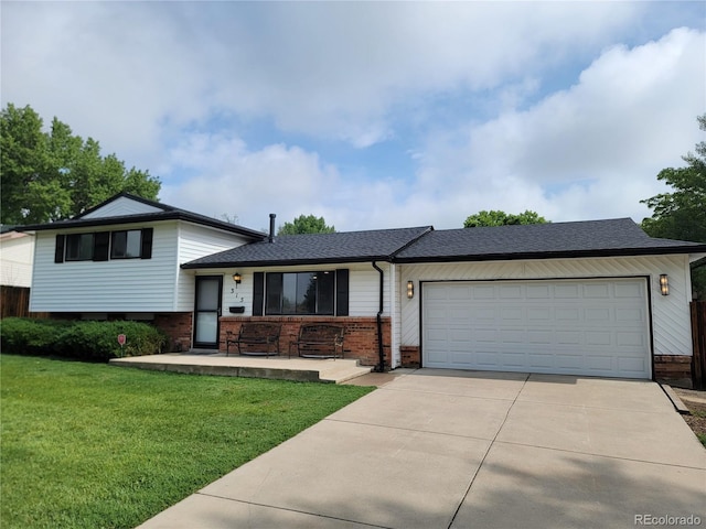 315 E 112th Dr, Northglenn, CO 80233 - tri-level home featuring brick siding, driveway, a garage, a front lawn, and a shingled roof