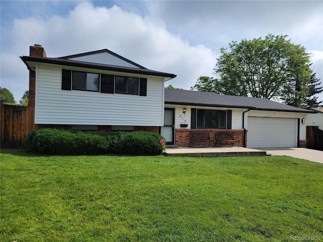 315 E 112th Dr, Northglenn, CO 80233 - split level home with an attached garage, a chimney, driveway, and brick siding