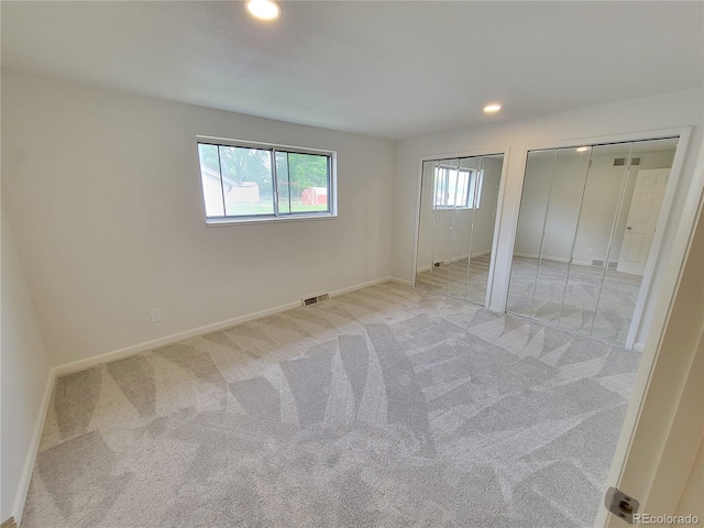 315 E 112th Dr, Northglenn, CO 80233 - unfurnished bedroom with multiple closets, baseboards, light colored carpet, and recessed lighting