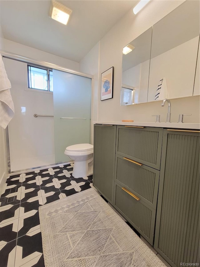 315 E 112th Dr, Northglenn, CO 80233 - bathroom with walk in shower, vanity, toilet, and tile patterned floors