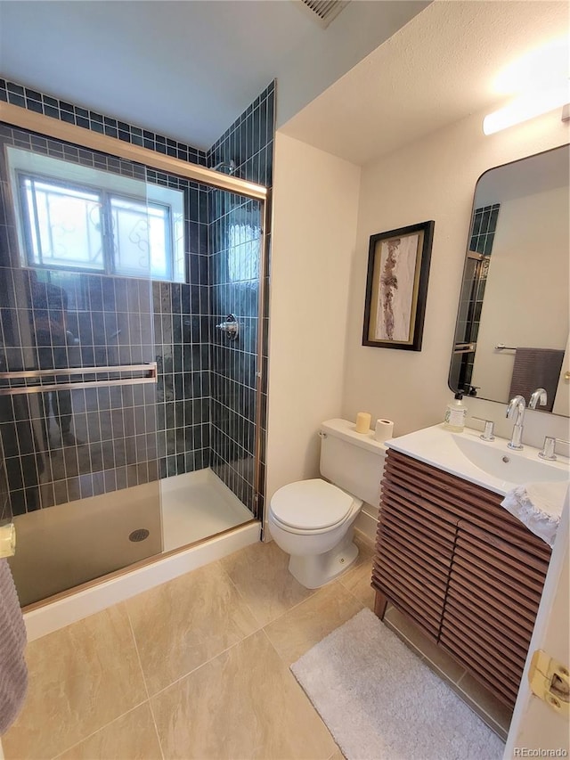 315 E 112th Dr, Northglenn, CO 80233 - bathroom featuring toilet, vanity, tiled shower, and tile patterned floors