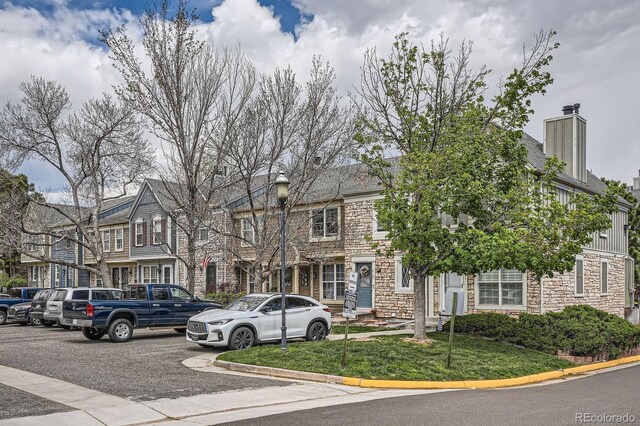 8197 S Fillmore Way, Centennial, CO 80122 - multi unit property with stone siding, a chimney, and a front lawn