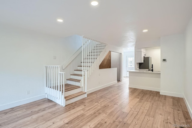 8197 S Fillmore Way, Centennial, CO 80122 - unfurnished living room with stairway, light wood-type flooring, baseboards, and recessed lighting