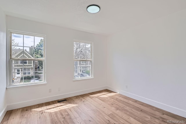 8197 S Fillmore Way, Centennial, CO 80122 - spare room with plenty of natural light, baseboards, and light wood-type flooring