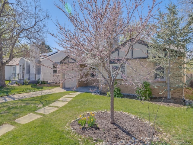 view of yard with a garage and driveway