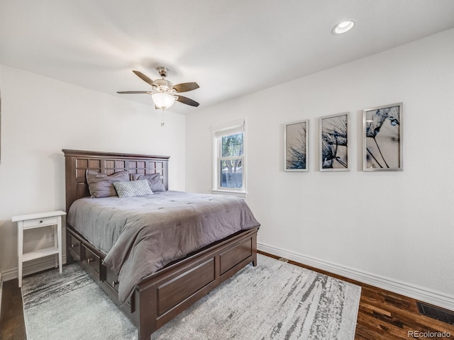 bedroom with ceiling fan, visible vents, wood finished floors, baseboards, and recessed lighting