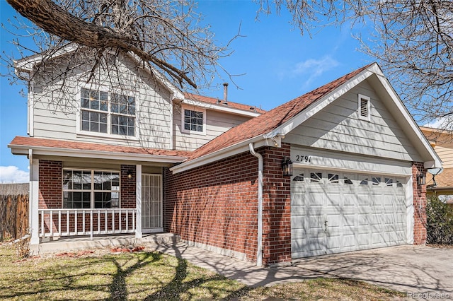view of front of home featuring driveway, covered porch, an attached garage, and brick siding