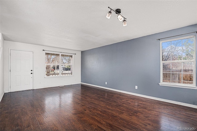 2791 S Bahama Ct, Aurora, CO 80013 - unfurnished room featuring wood finished floors, a textured ceiling, and baseboards