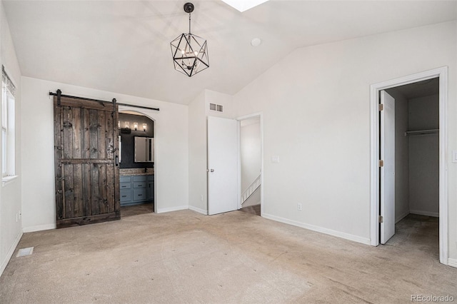 2791 S Bahama Ct, Aurora, CO 80013 - unfurnished bedroom featuring lofted ceiling, carpet floors, a walk in closet, baseboards, and connected bathroom