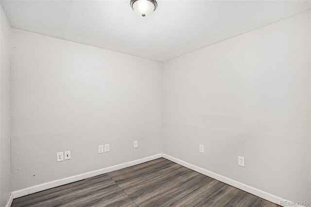 2791 S Bahama Ct, Aurora, CO 80013 - empty room featuring baseboards and dark wood-style flooring