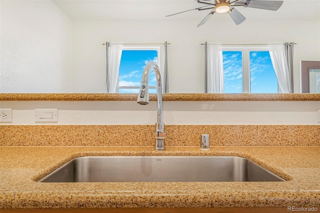 details featuring a ceiling fan, light countertops, and a sink