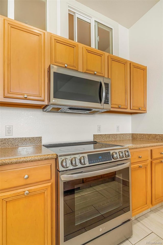 kitchen featuring light countertops and appliances with stainless steel finishes