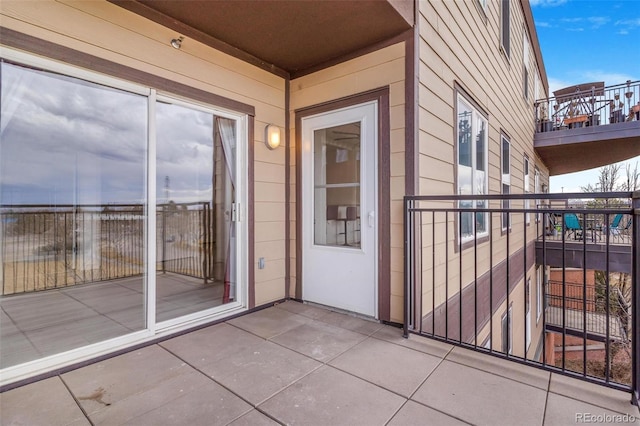 view of exterior entry featuring a balcony