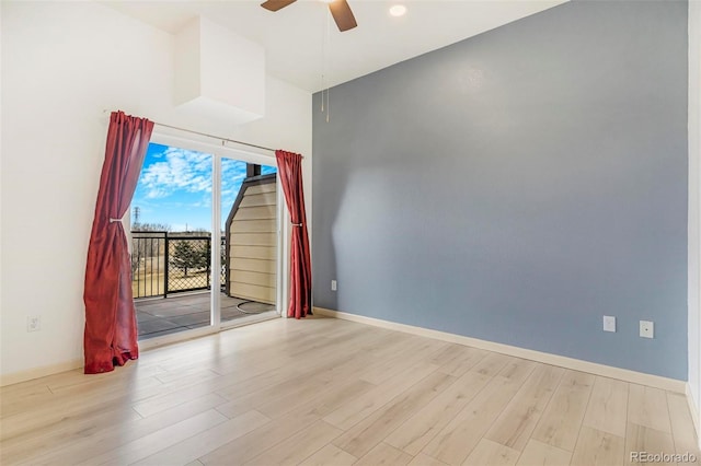 empty room with ceiling fan, wood finished floors, and baseboards