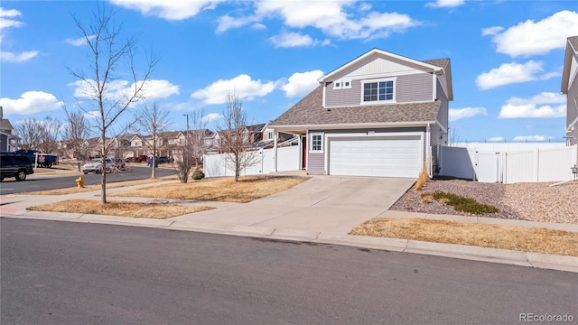 view of front of property with an attached garage, fence, roof with shingles, driveway, and a gate