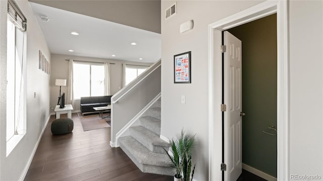 stairs with recessed lighting, wood finished floors, visible vents, and baseboards