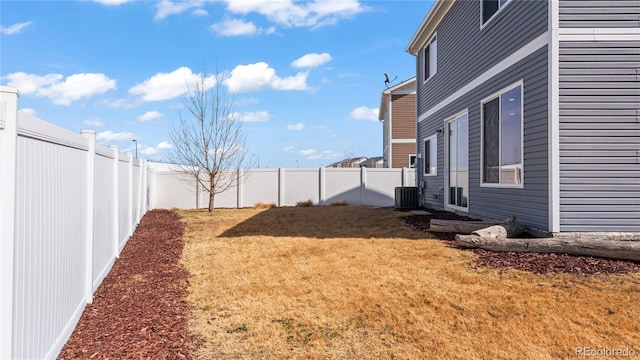 view of yard featuring central AC and a fenced backyard