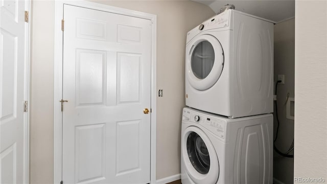 clothes washing area featuring laundry area and stacked washer / drying machine