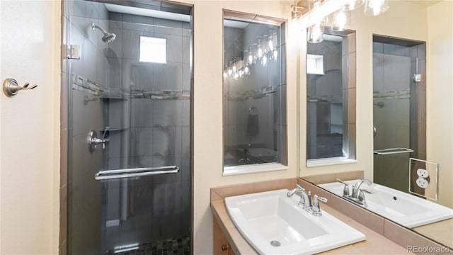 full bath with a stall shower and vanity