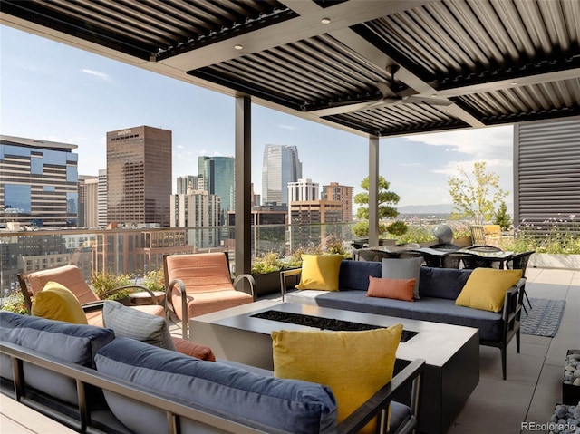 view of patio / terrace featuring ceiling fan and an outdoor living space with a fire pit