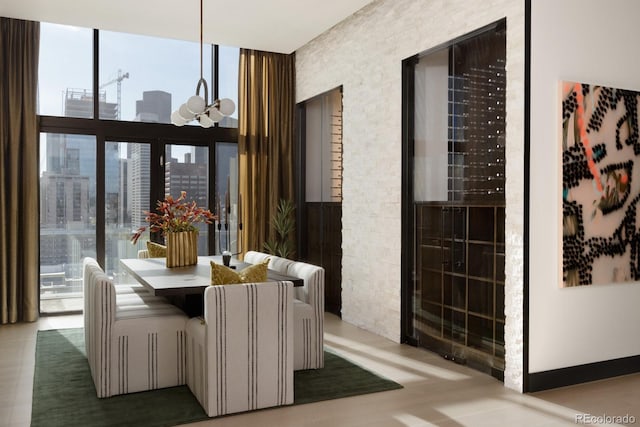 dining area with light hardwood / wood-style flooring, floor to ceiling windows, and a chandelier